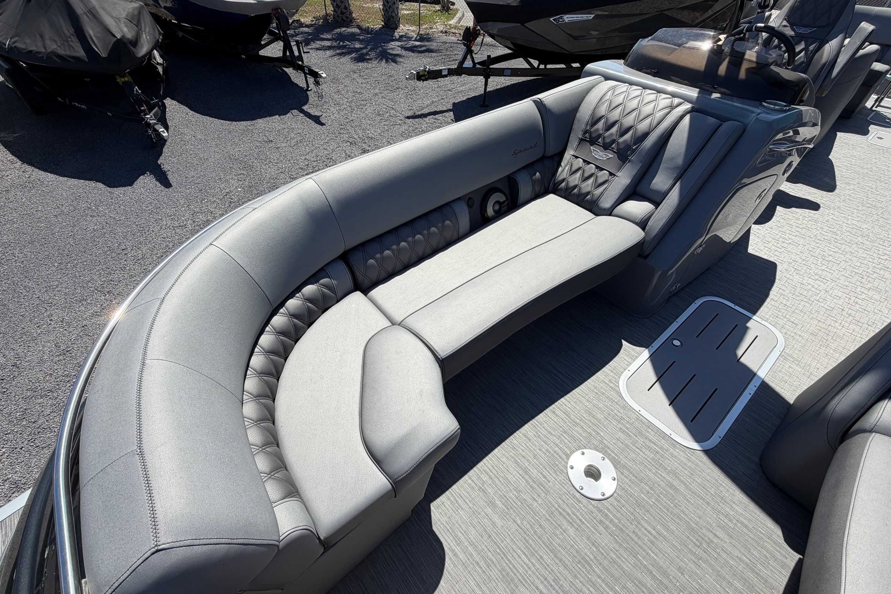 2022 Bennington 25 QX boat interior with luxurious gray seating and modern design.