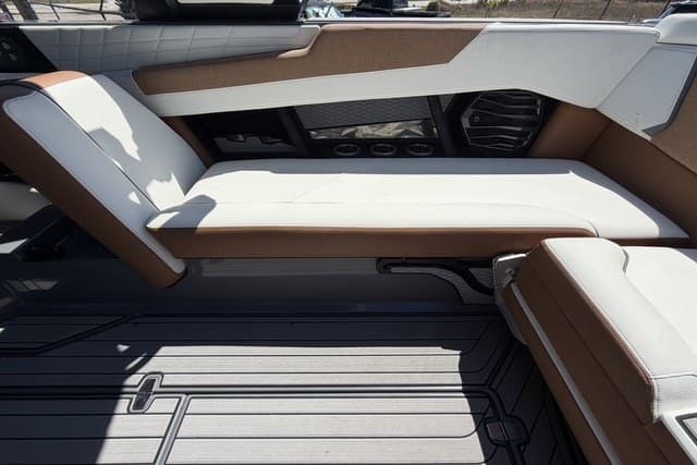 2022 Nautique Super Air Nautique G25 interior seating with brown and white upholstery.