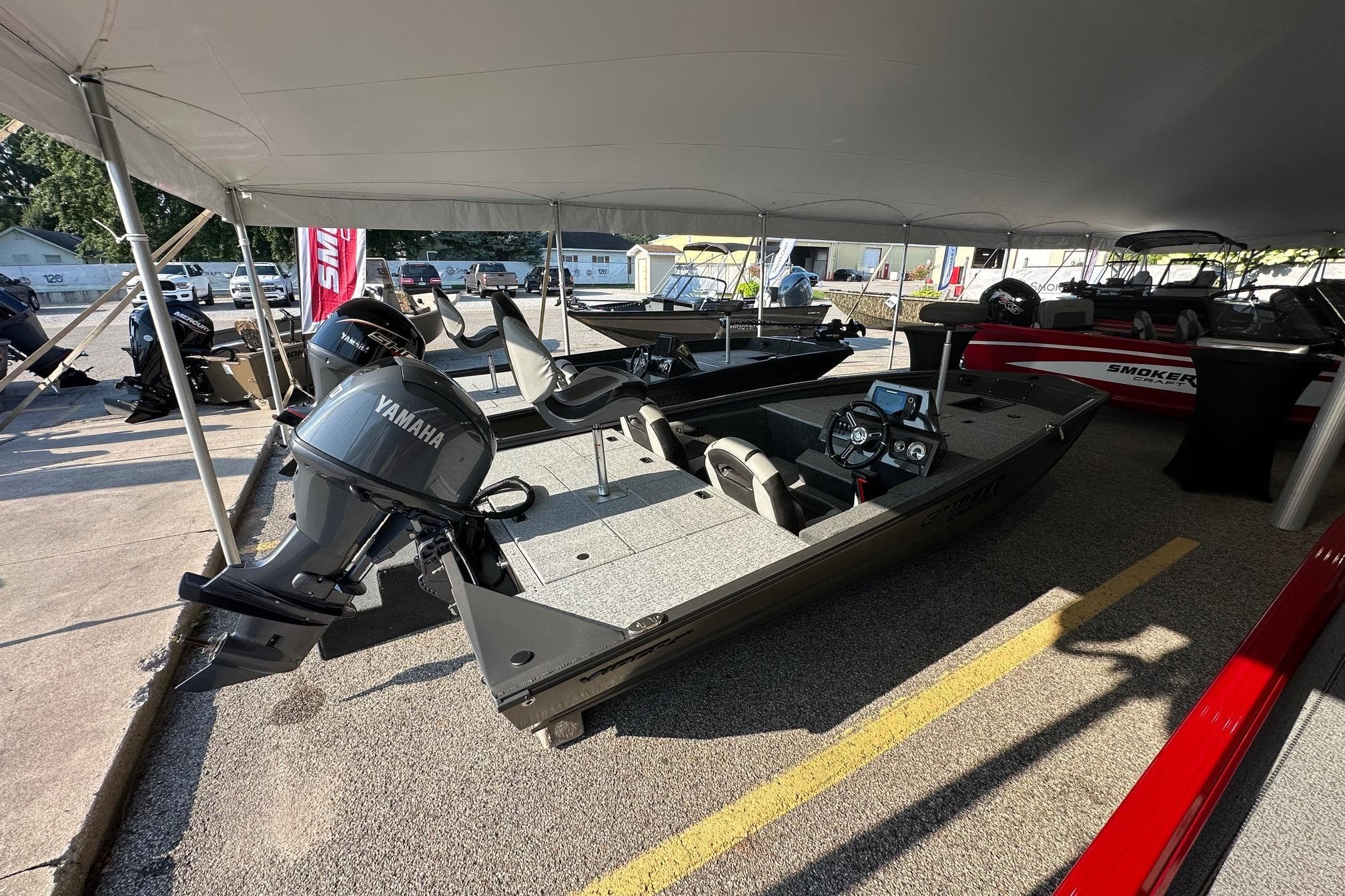 2026 Smoker Craft VIPER 175 boat with Yamaha engine displayed under a tent.