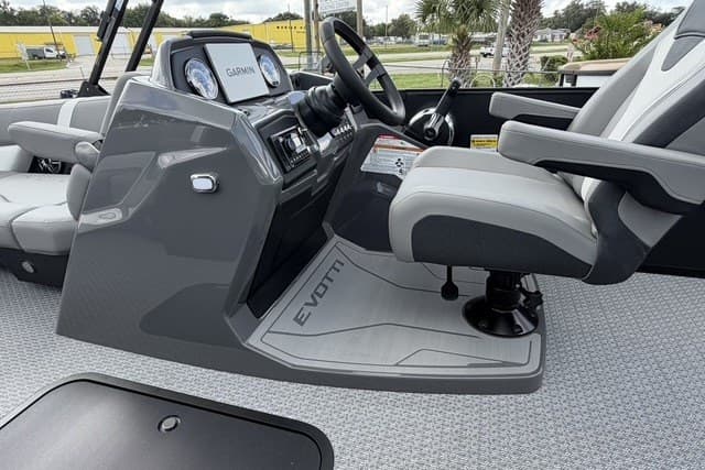 Captain's seat and dashboard of 2027 Evotti 523CS boat, featuring Garmin navigation system.