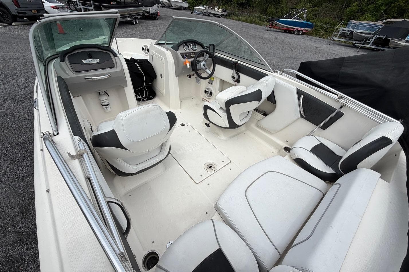 Interior of a 2020 Chaparral 196 SSi boat with white seating and steering console.