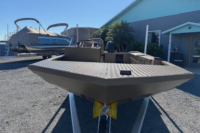 2026 Smoker Craft Pro Sportsman 1660 boat displayed outdoors on a trailer.