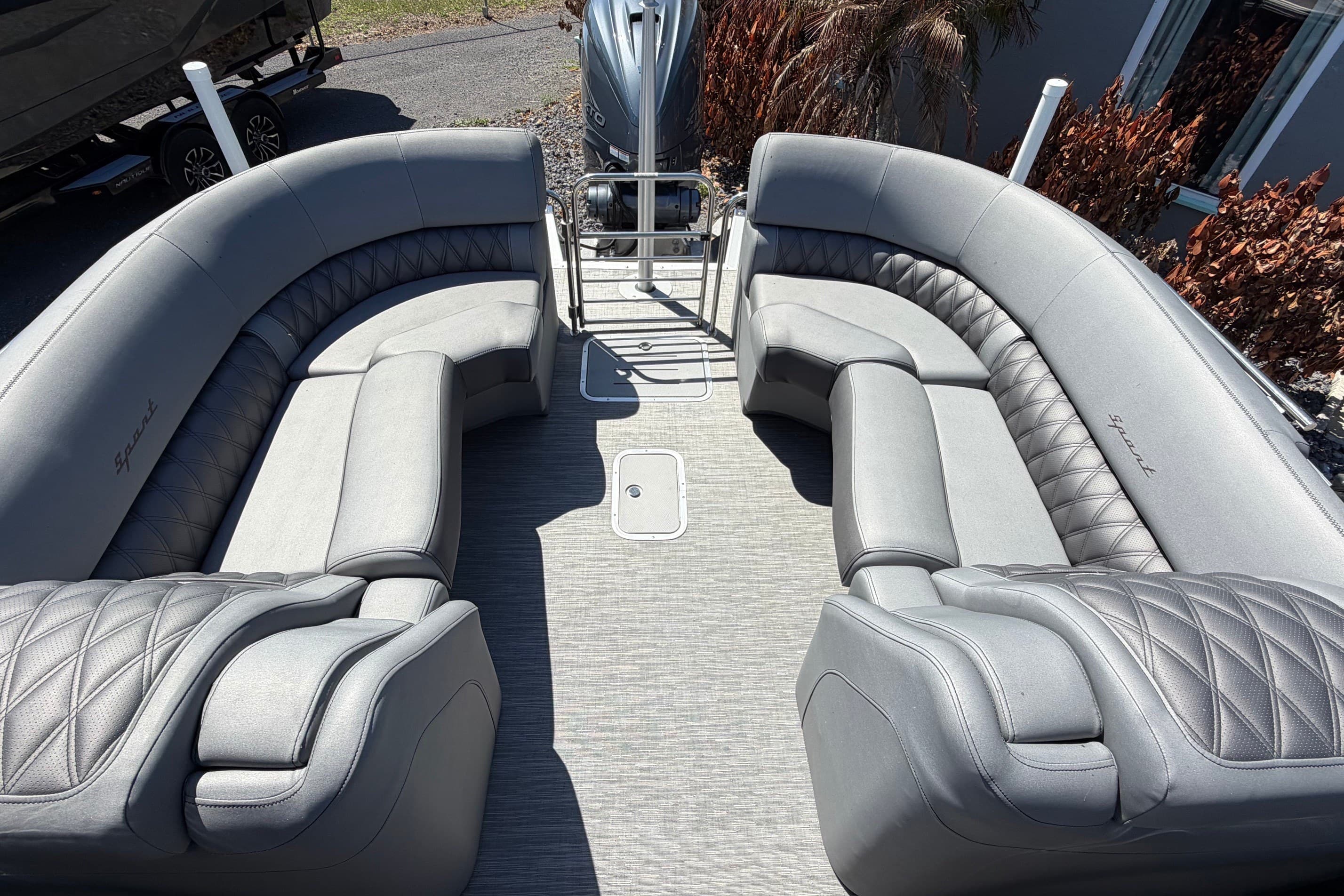 2022 Bennington 25 QX boat interior with luxurious gray seating and spacious layout.