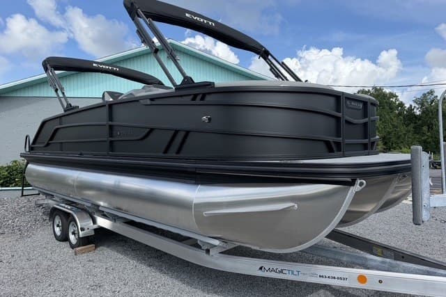 2027 Evotti 523CS pontoon boat on trailer, sleek black design, parked outdoors.