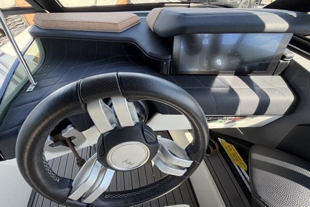 2022 Nautique Super Air Nautique G25 dashboard with modern steering and touchscreen display.