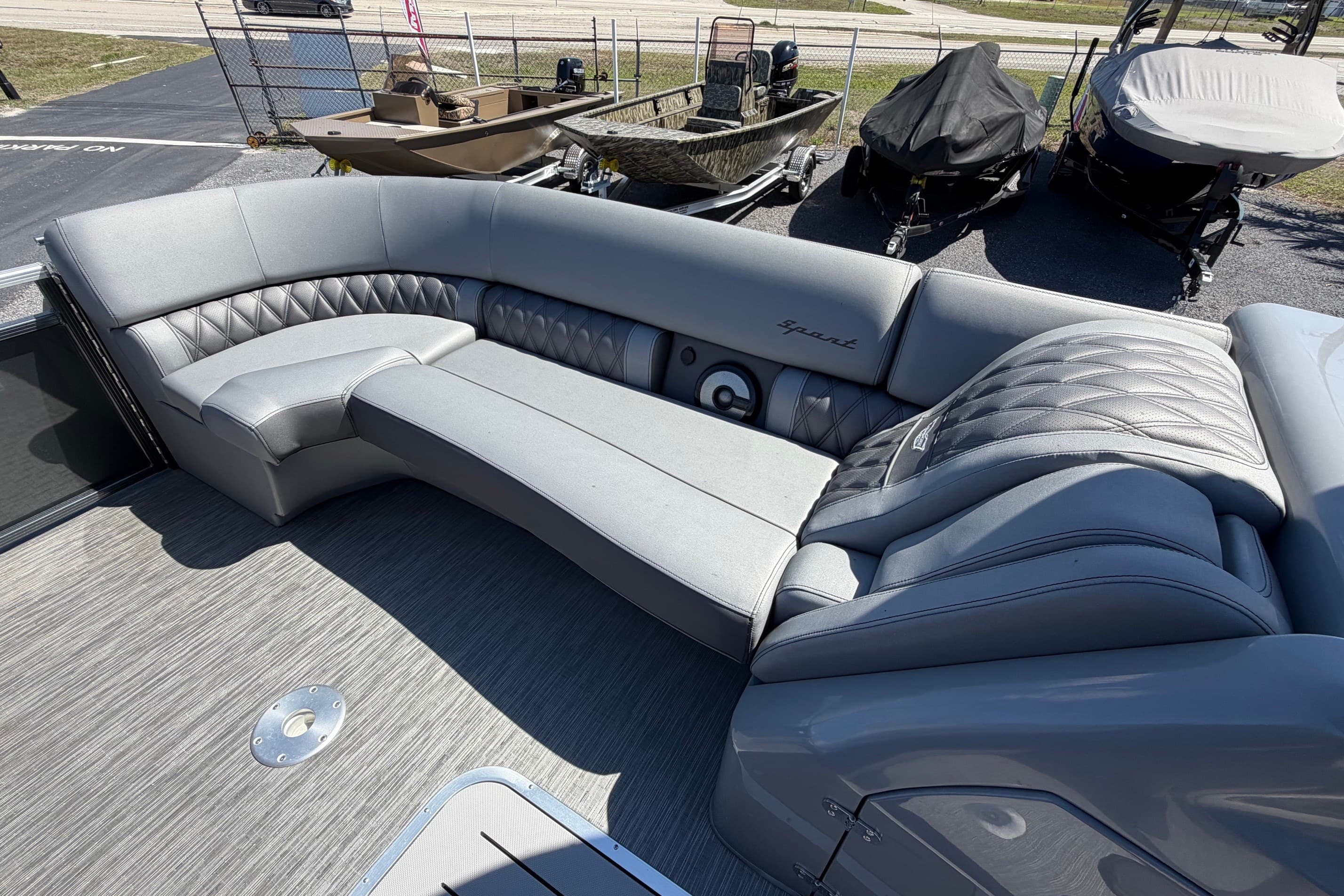 2022 Bennington 25 QX boat interior with luxurious gray seating and quilted design.
