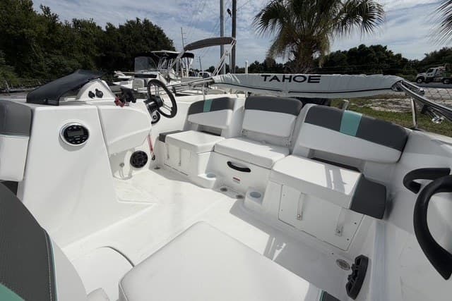 2025 Tahoe T18 boat interior with seating, steering wheel, and storage compartments.