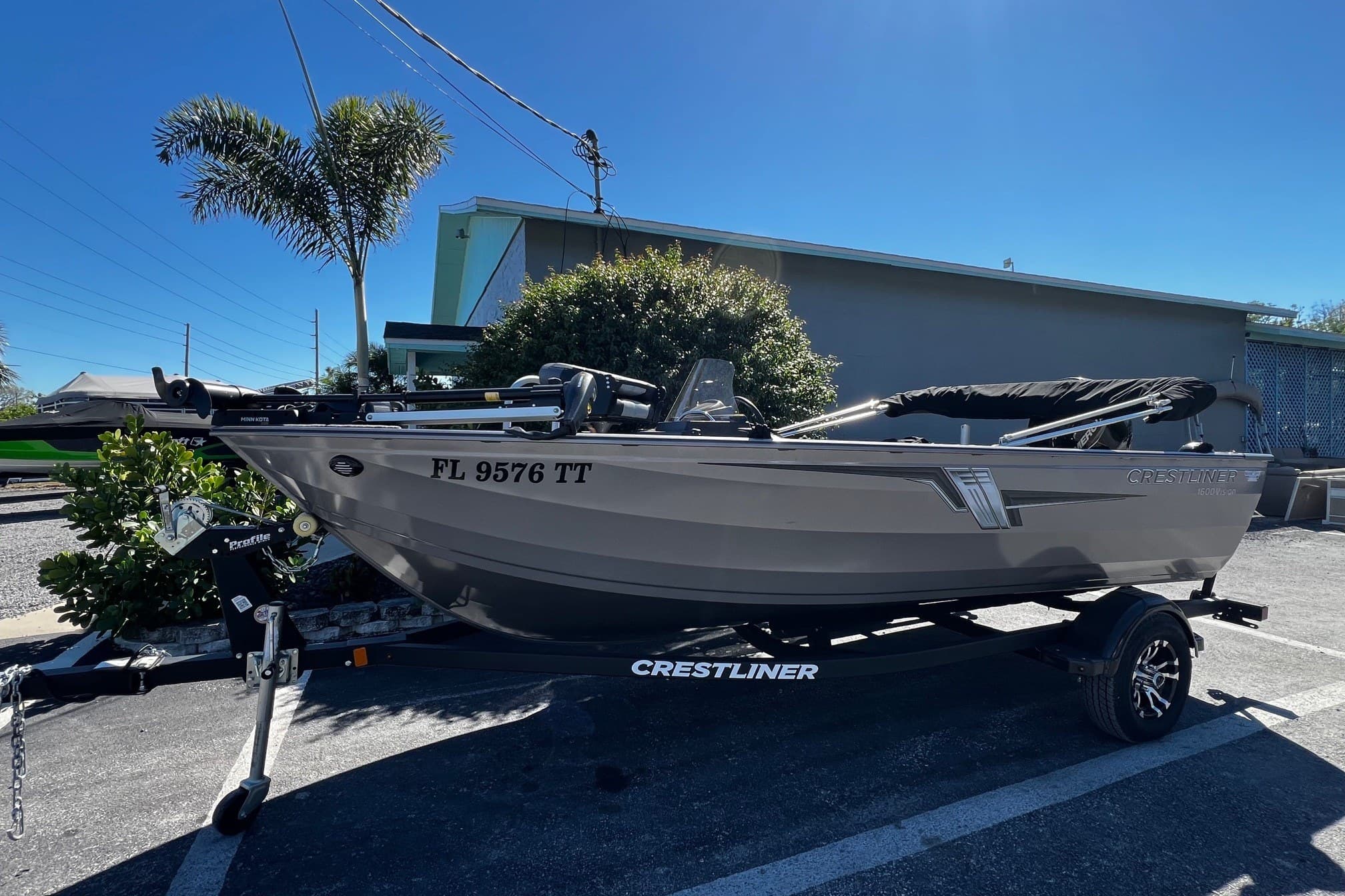 2023 Crestliner 1600 Vision boat on trailer, parked outdoors under clear sky.