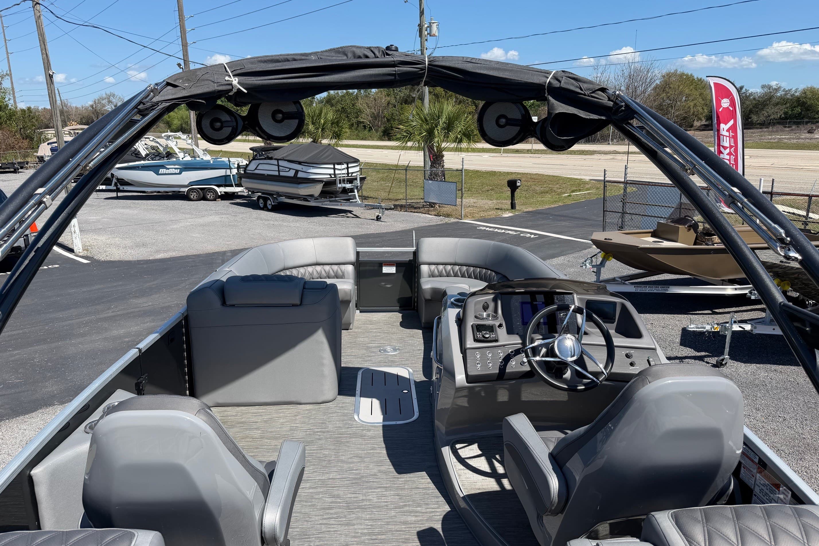 2022 Bennington 25 QX pontoon boat interior with helm, seating, and canopy.