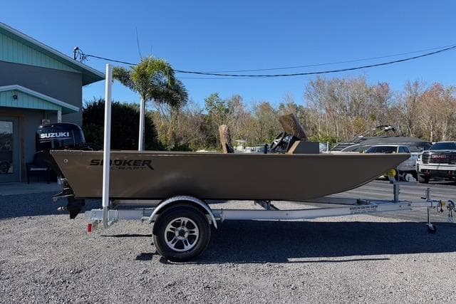 2026 Smoker Craft Pro Sportsman 1660 boat on trailer, parked outdoors.