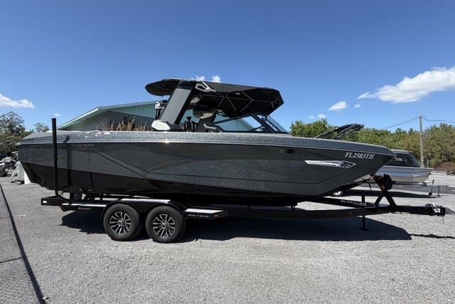 2022 Nautique Super Air Nautique G25 boat on trailer, parked outdoors under clear sky.