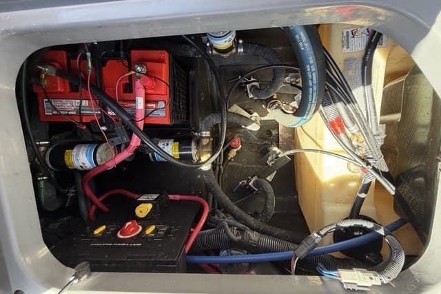 Engine compartment of 2022 Nautique Super Air Nautique G25 with visible wiring and components.