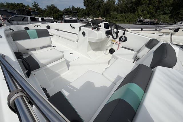 2025 Tahoe T18 boat interior with modern seating and steering, docked outdoors.