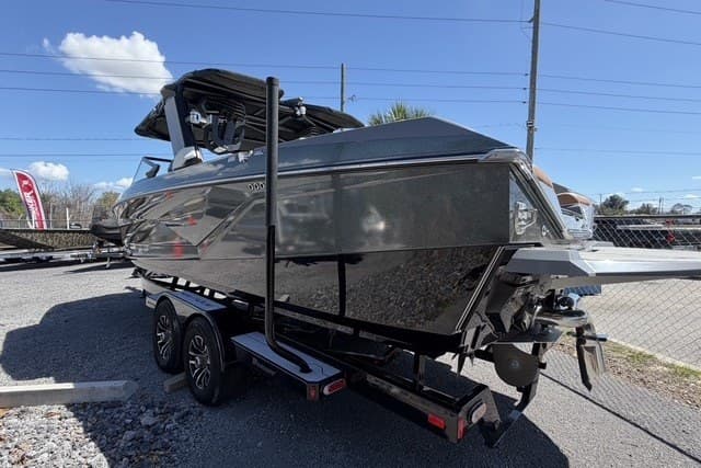 2022 Nautique Super Air Nautique G25 boat on trailer, parked outdoors.