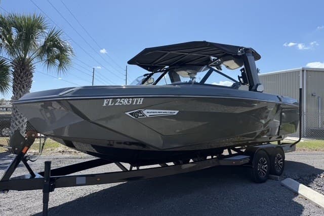 2022 Nautique Super Air Nautique G25 boat on trailer, parked outdoors under clear sky.
