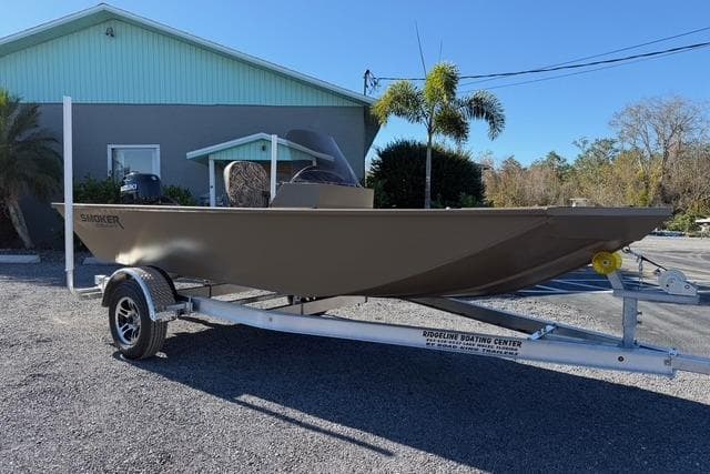 2026 Smoker Craft Pro Sportsman 1660 boat on trailer, parked outdoors.