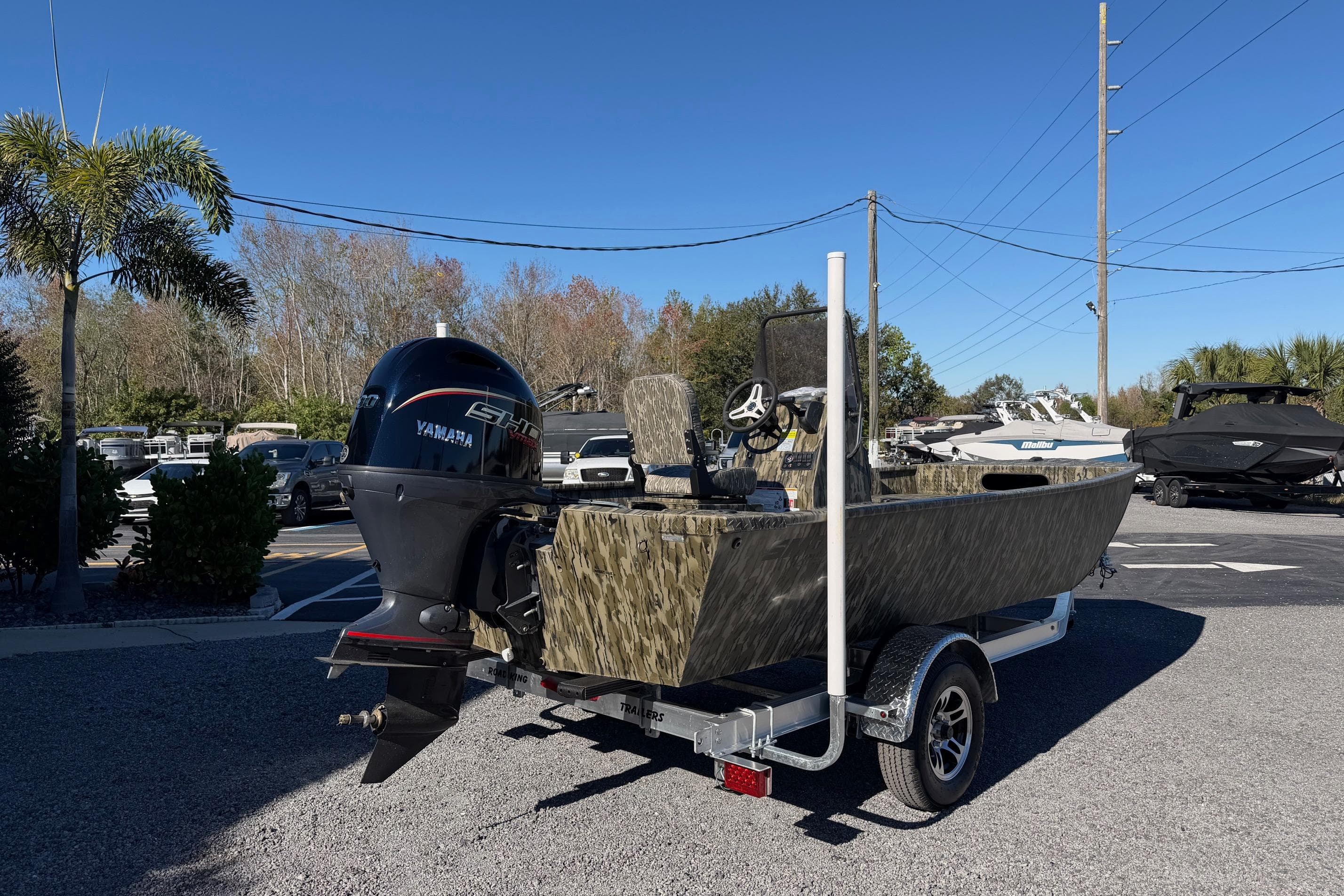 2026 Smoker Craft Sportsman 1866 boat with Yamaha engine on trailer, parked outdoors.