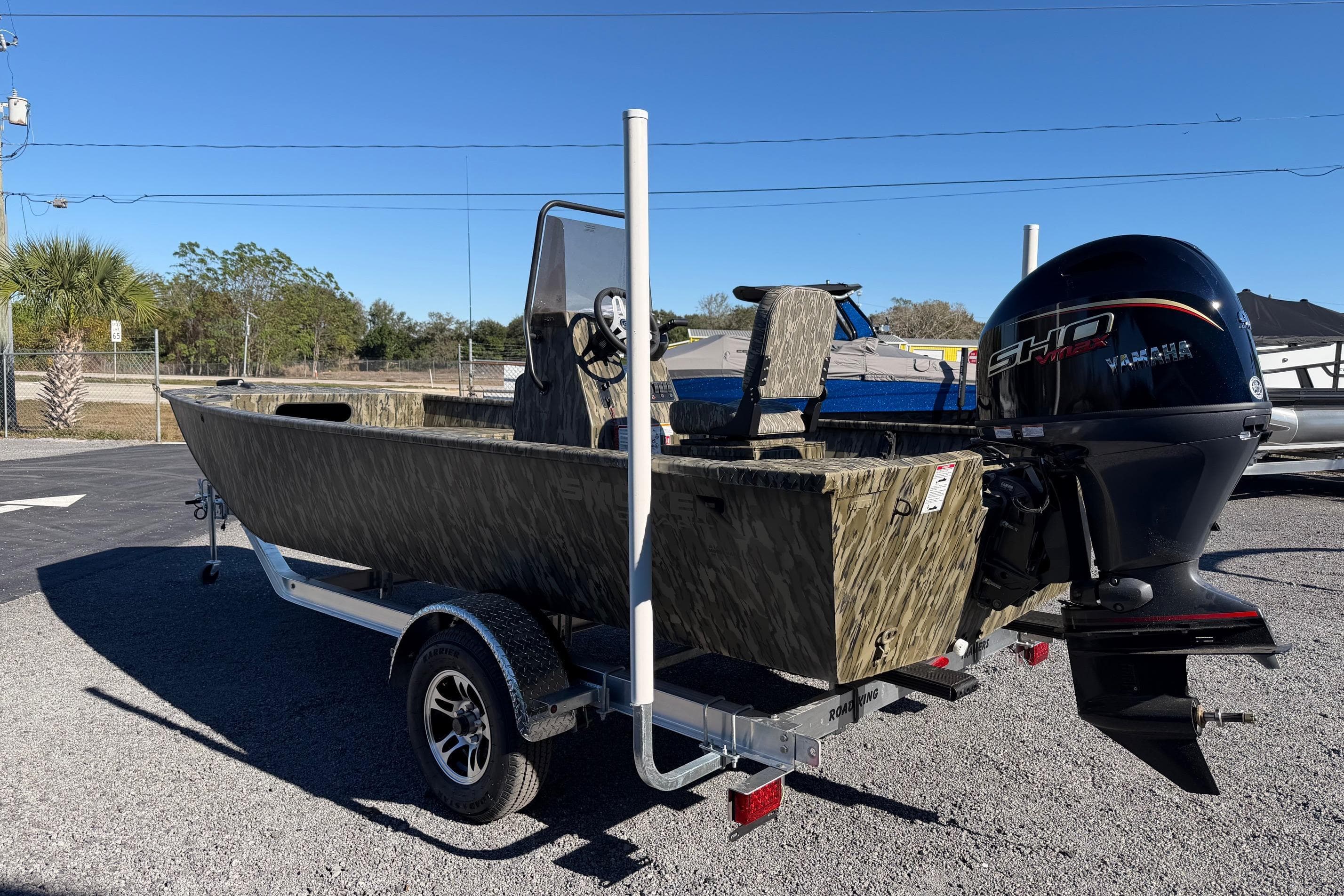 2026 Smoker Craft Sportsman 1866 boat with Yamaha engine on trailer, outdoors.