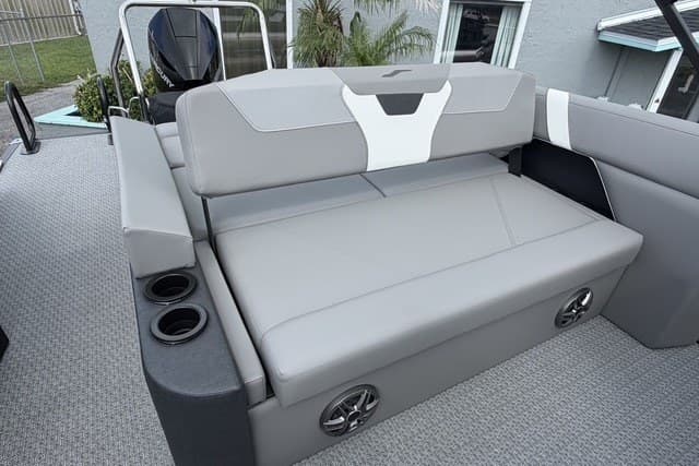 Luxurious seating on 2027 Evotti 523CS boat with cup holders and modern design.