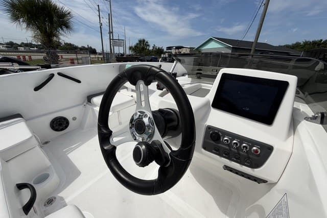 2025 Tahoe T18 boat cockpit with steering wheel and control panel.