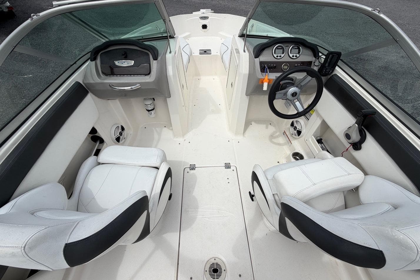 2020 Chaparral 196 SSi boat interior with white seating and modern dashboard.