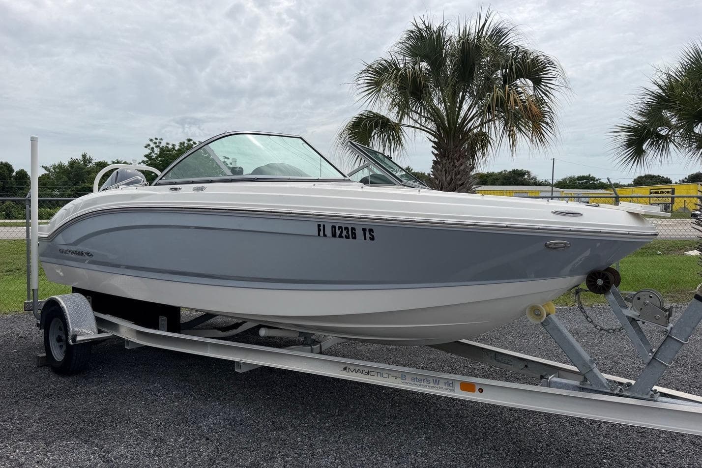 2020 Chaparral 196 SSi boat on trailer, parked near palm trees.