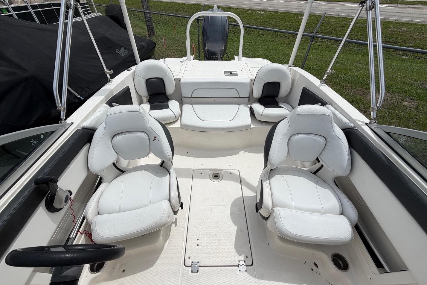 2020 Chaparral 196 SSi boat interior with white seating and steering wheel.