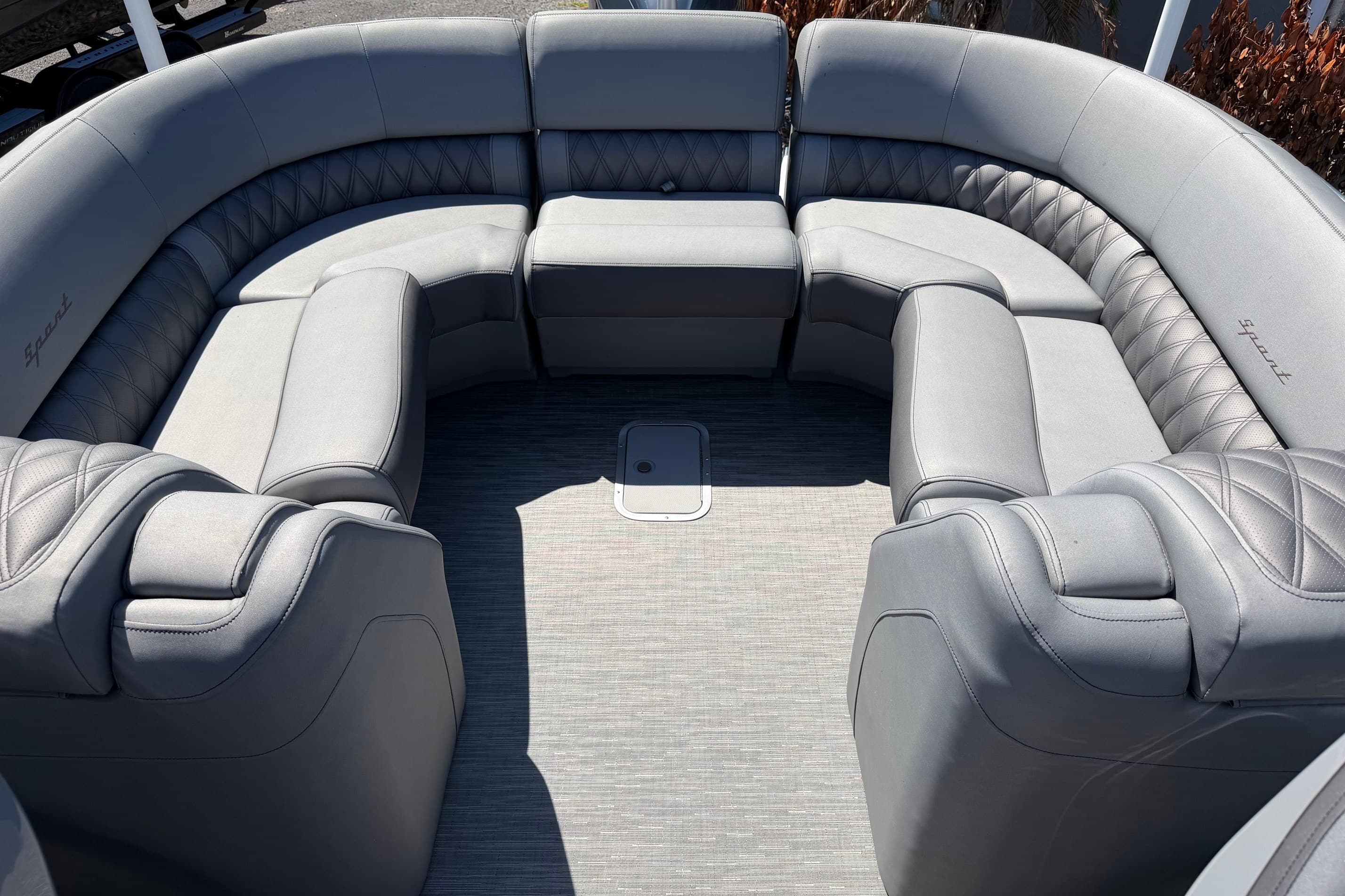 Luxurious seating on 2022 Bennington 25 QX boat, featuring elegant gray upholstery.