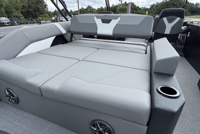 Luxurious seating area on 2027 Evotti 523CS boat with gray upholstery and cup holder.