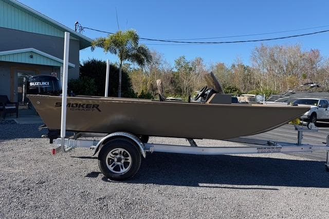 2026 Smoker Craft Pro Sportsman 1660 boat on trailer, parked outdoors.