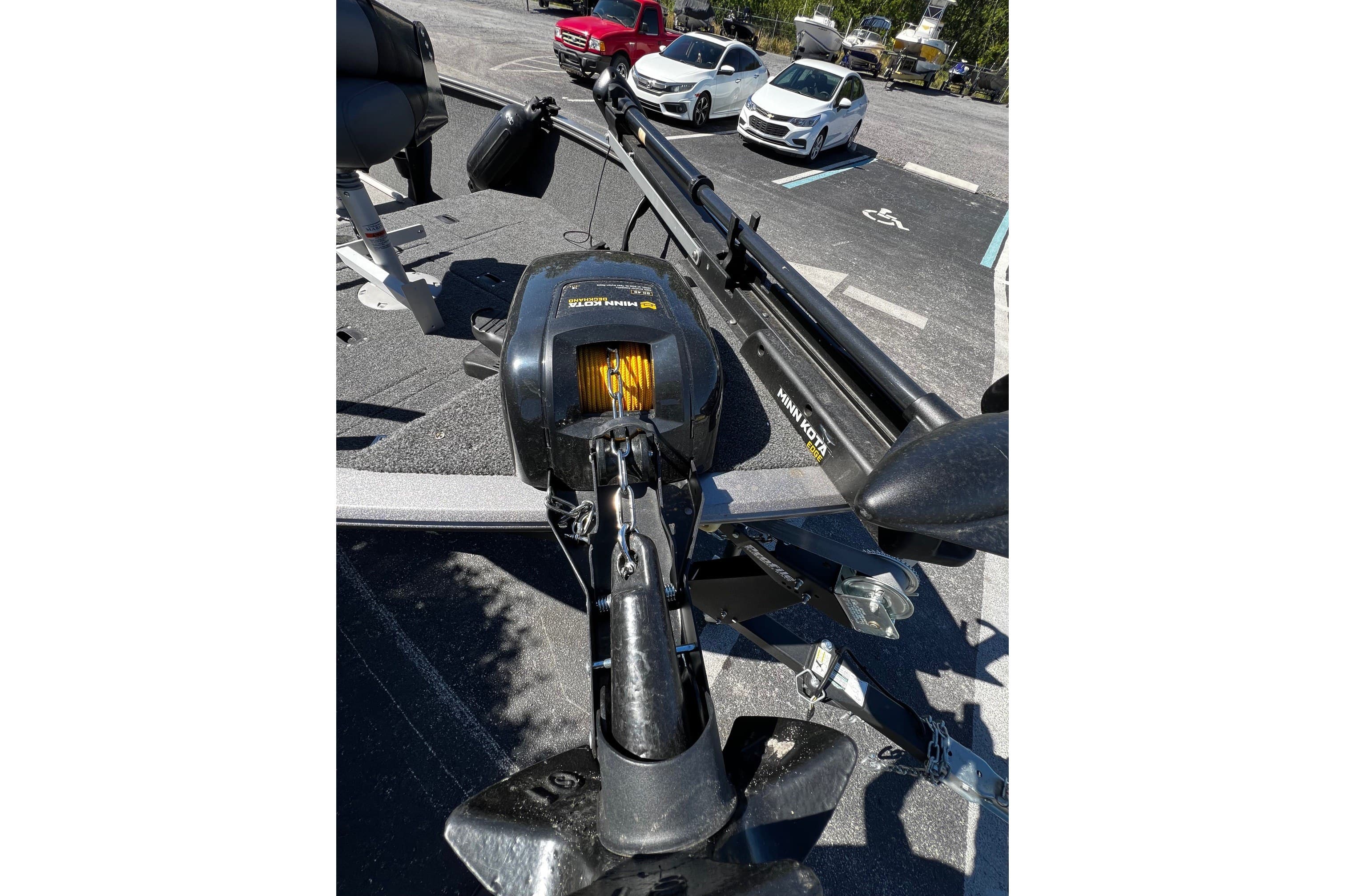 2023 Crestliner 1600 Vision boat with Minn Kota trolling motor in parking lot.
