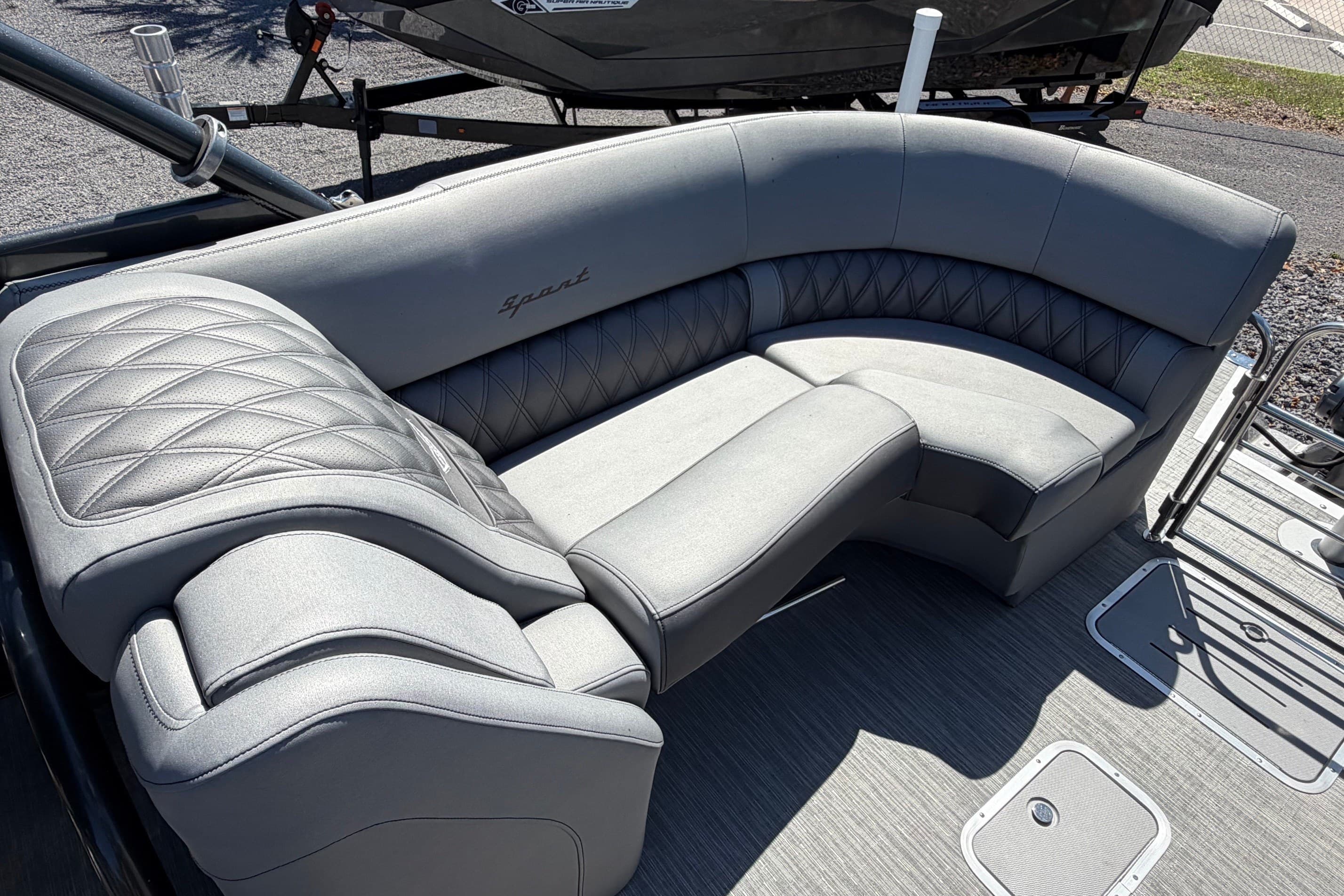 Luxurious seating on 2022 Bennington 25 QX boat, featuring elegant gray upholstery.
