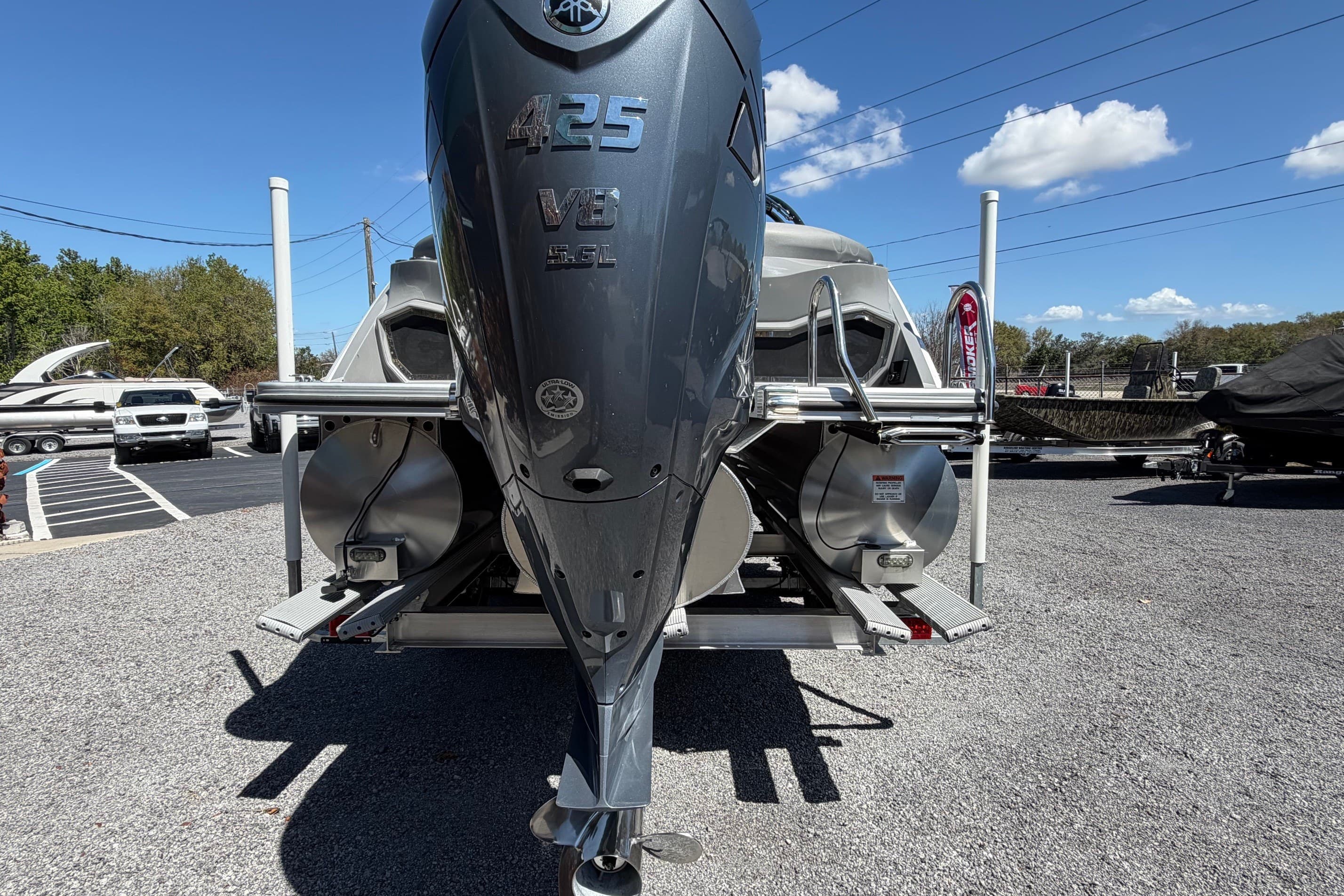 2022 Bennington 25 QX boat with powerful 425 V8 engine displayed outdoors.