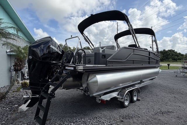 2027 Evotti 523CS pontoon boat on trailer, featuring sleek design and powerful outboard motor.
