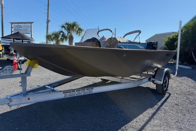 2026 Smoker Craft Pro Sportsman 1660 boat on trailer in sunny outdoor setting.