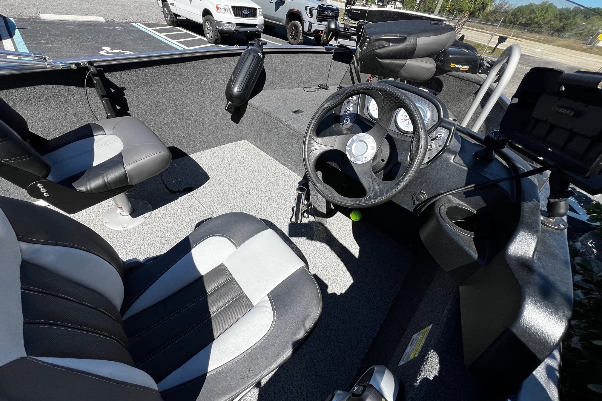 Interior of 2023 Crestliner 1600 Vision boat with steering wheel and seats.