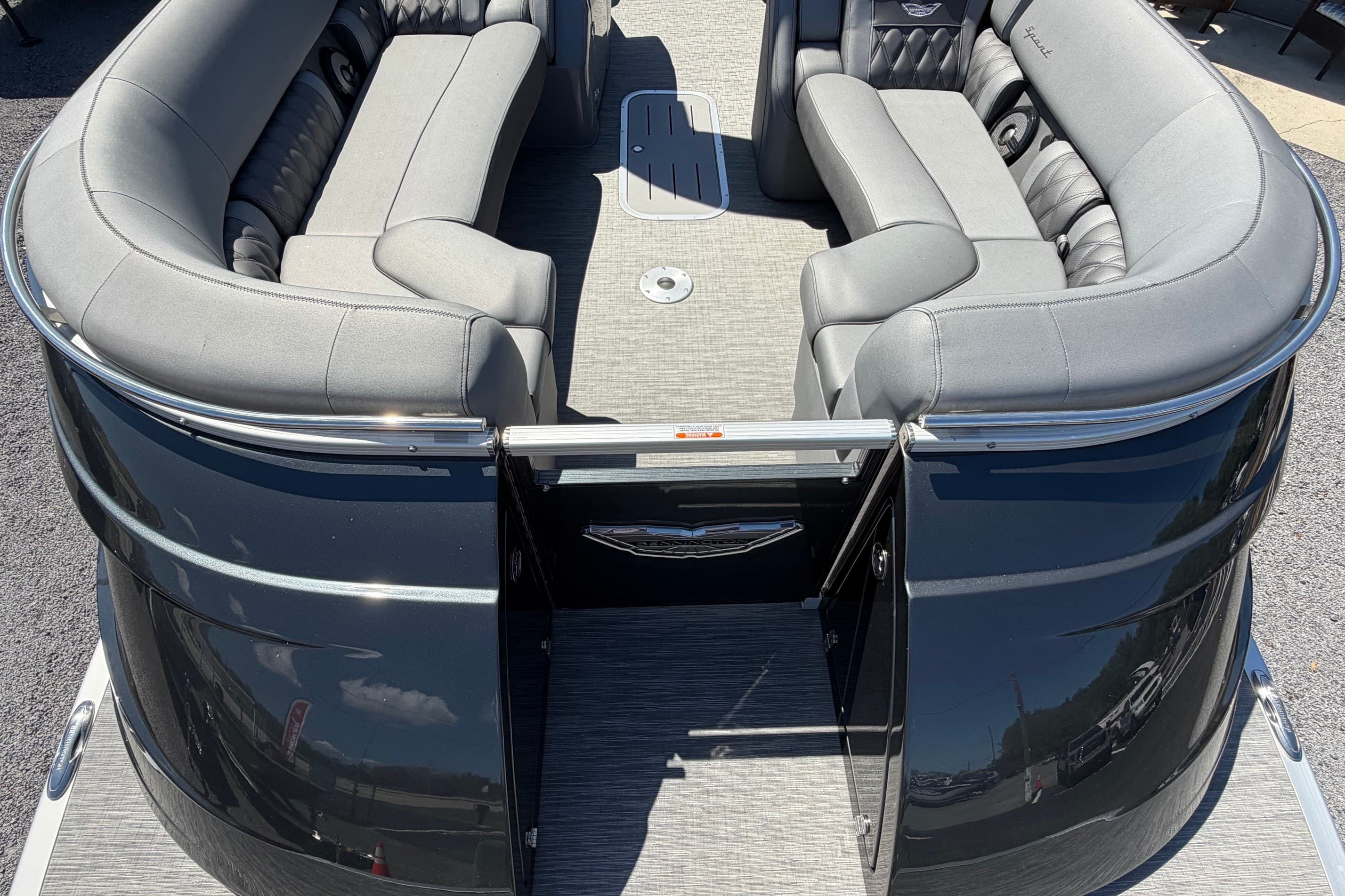 2022 Bennington 25 QX pontoon boat with luxurious gray seating and sleek black exterior.