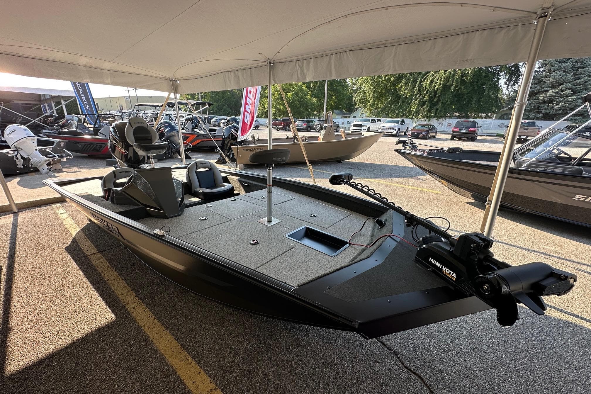 2026 Smoker Craft VIPER 175 boat displayed under a canopy at a dealership.