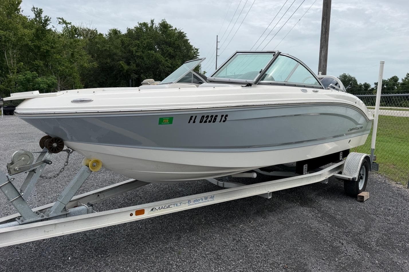 2020 Chaparral 196 SSi boat on trailer, parked outdoors, showcasing sleek design.