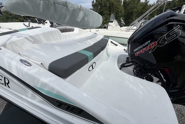 2025 Tahoe T18 boat with Mercury Pro XS engine, featuring sleek white design and cushioned seating.