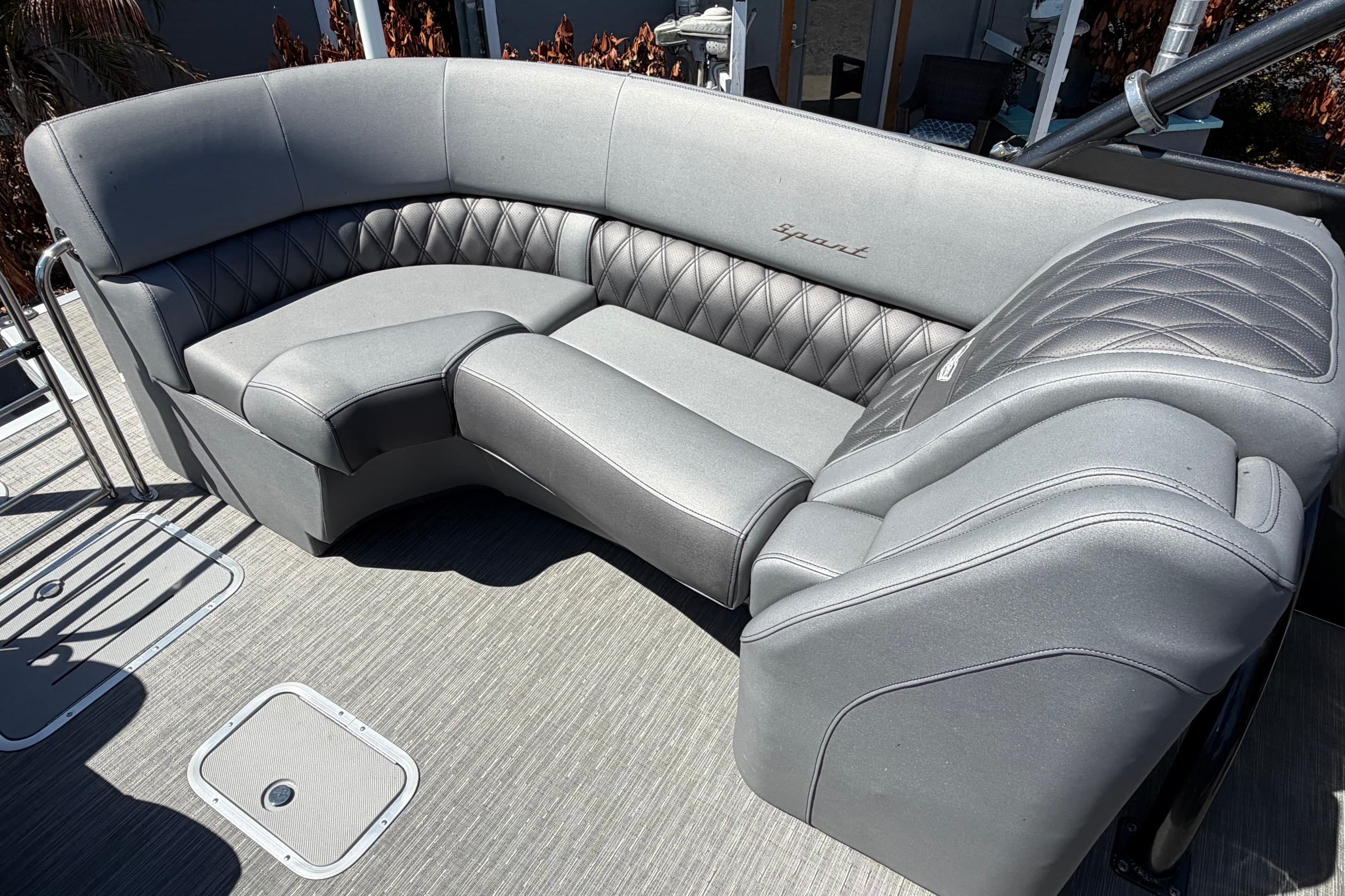 Luxurious seating on a 2022 Bennington 25 QX boat, featuring elegant gray upholstery.