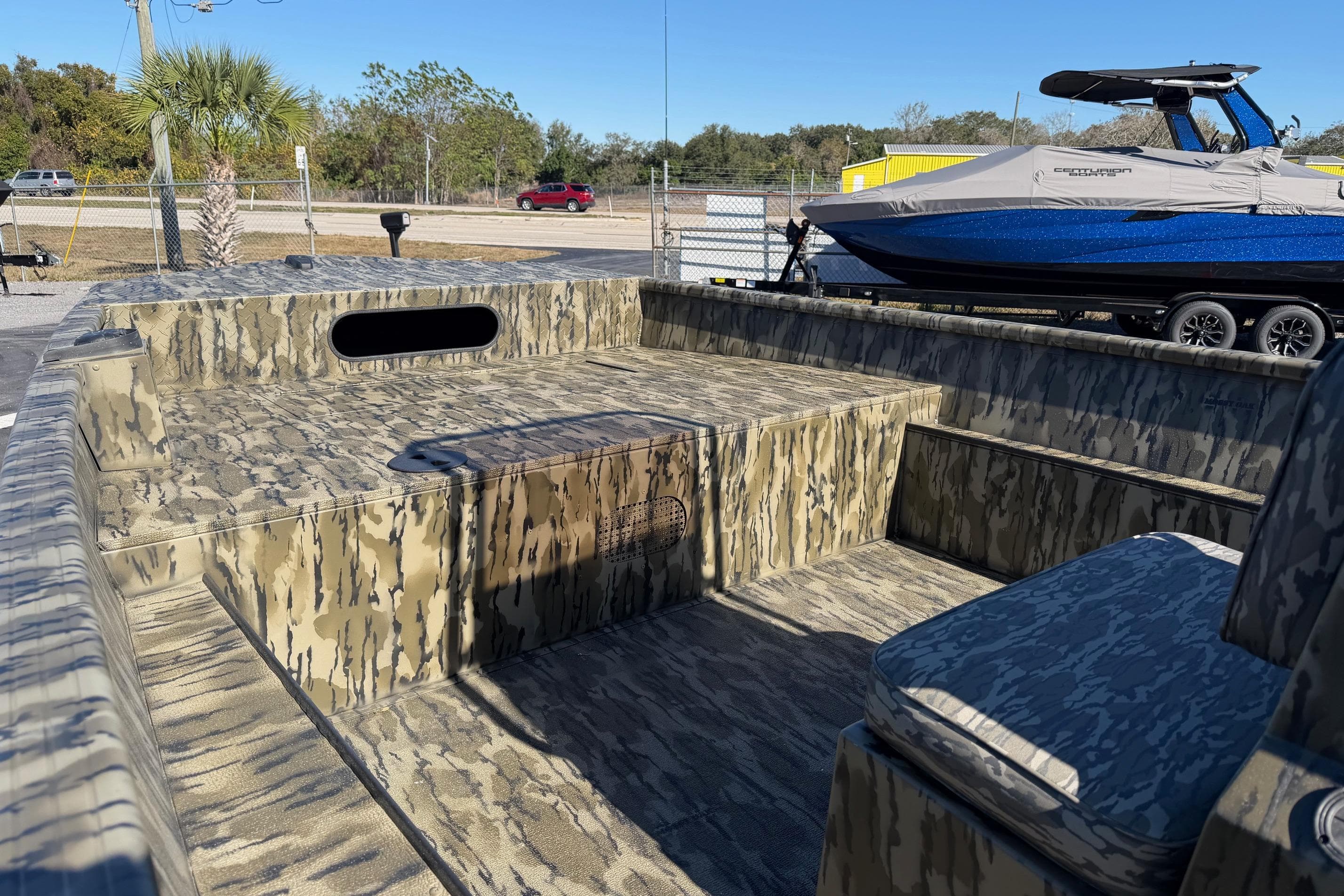 2026 Smoker Craft Sportsman 1866 boat with camouflage interior, parked outdoors.