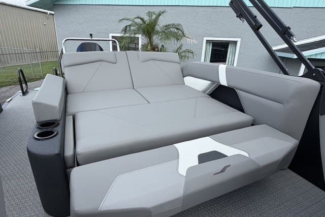 Luxurious seating on 2027 Evotti 523CS boat, featuring sleek gray upholstery and cup holders.