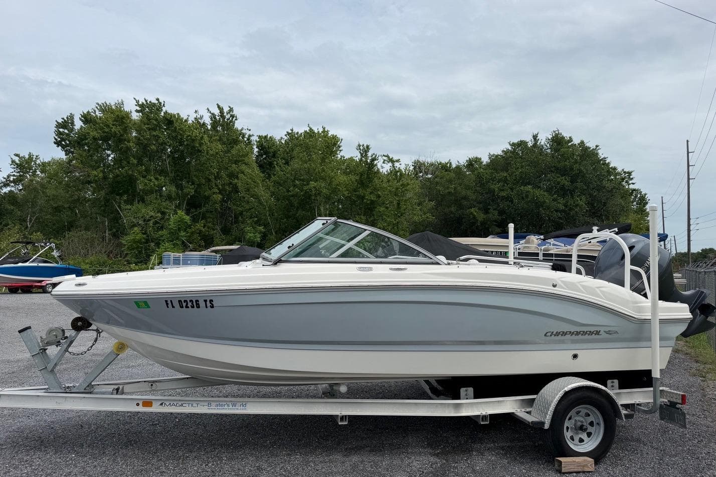 2020 Chaparral 196 SSi boat on trailer, parked outdoors with trees in background.