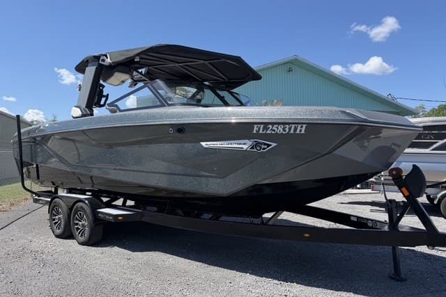 2022 Nautique Super Air Nautique G25 boat on trailer, parked outdoors.