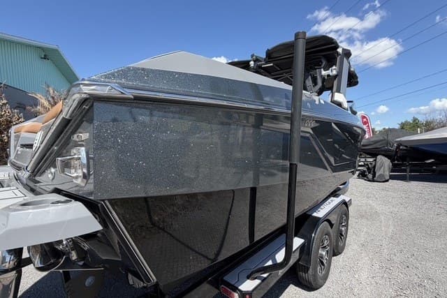 2022 Nautique Super Air Nautique G25 boat on trailer, metallic finish, sunny day.